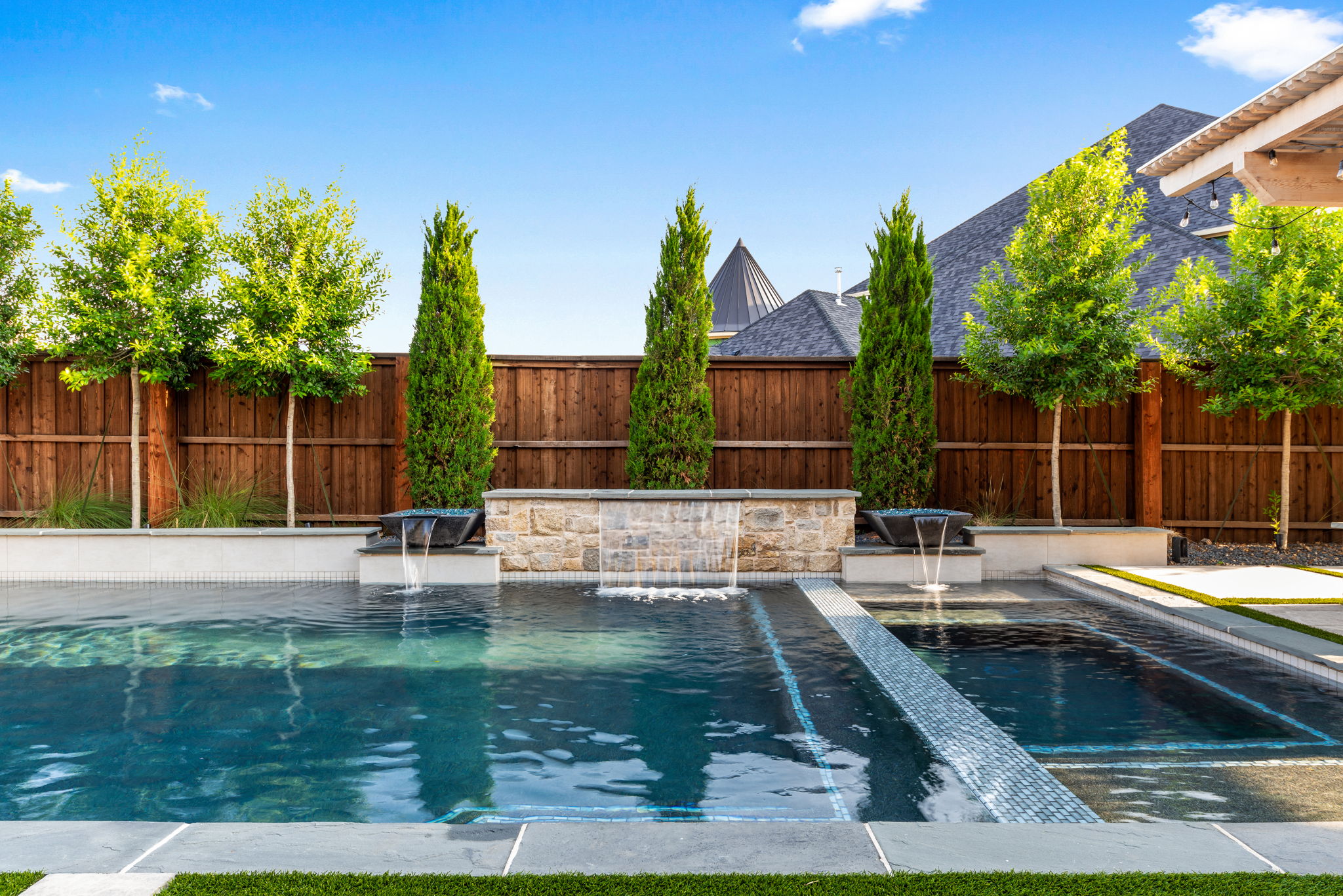 Swimming pool with retaining wall and water features